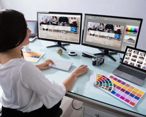 Close-up,Of,A,Female,Designer,Working,On,Multiple,Computer,At Close-up,Of,A,Female,Designer,Working,On,Multiple,Computer,At